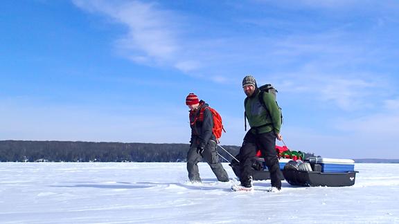 Ozersky and Kiril Shchapov pull a sled with research supplies on frozen lake