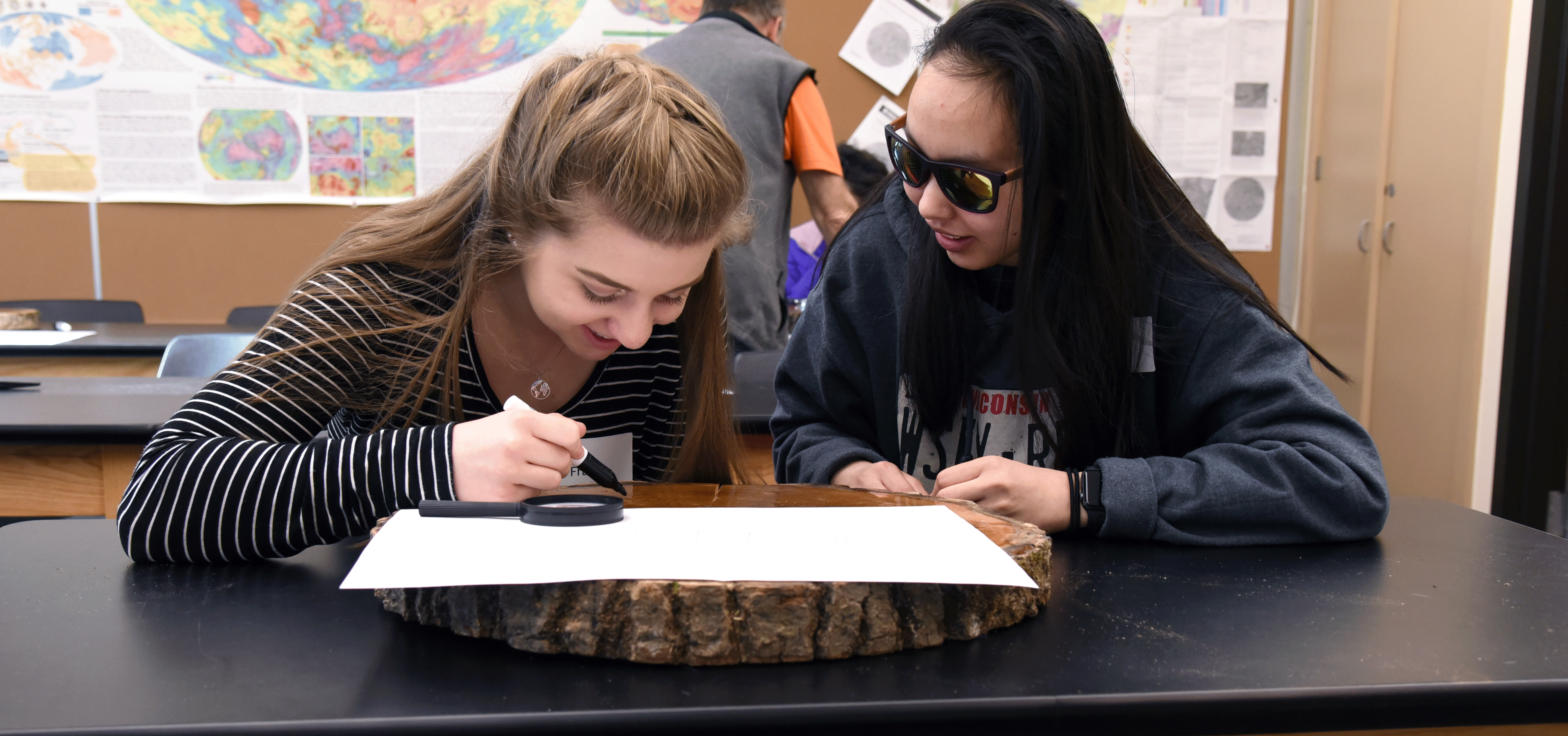 Students studying a tree ring at 2019 STEM Discovery Day