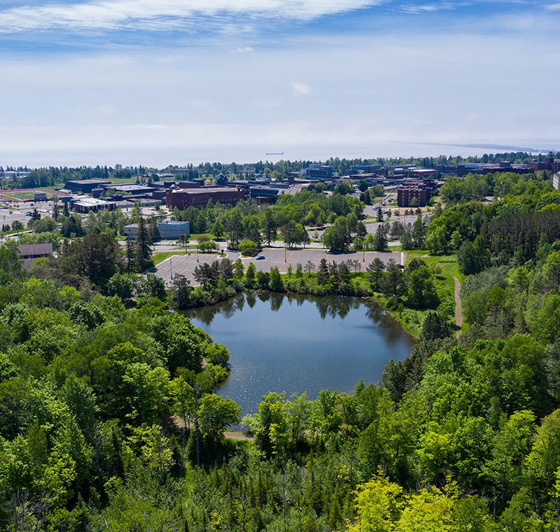 Aerial view of campus with Hartley Pond in the foreground