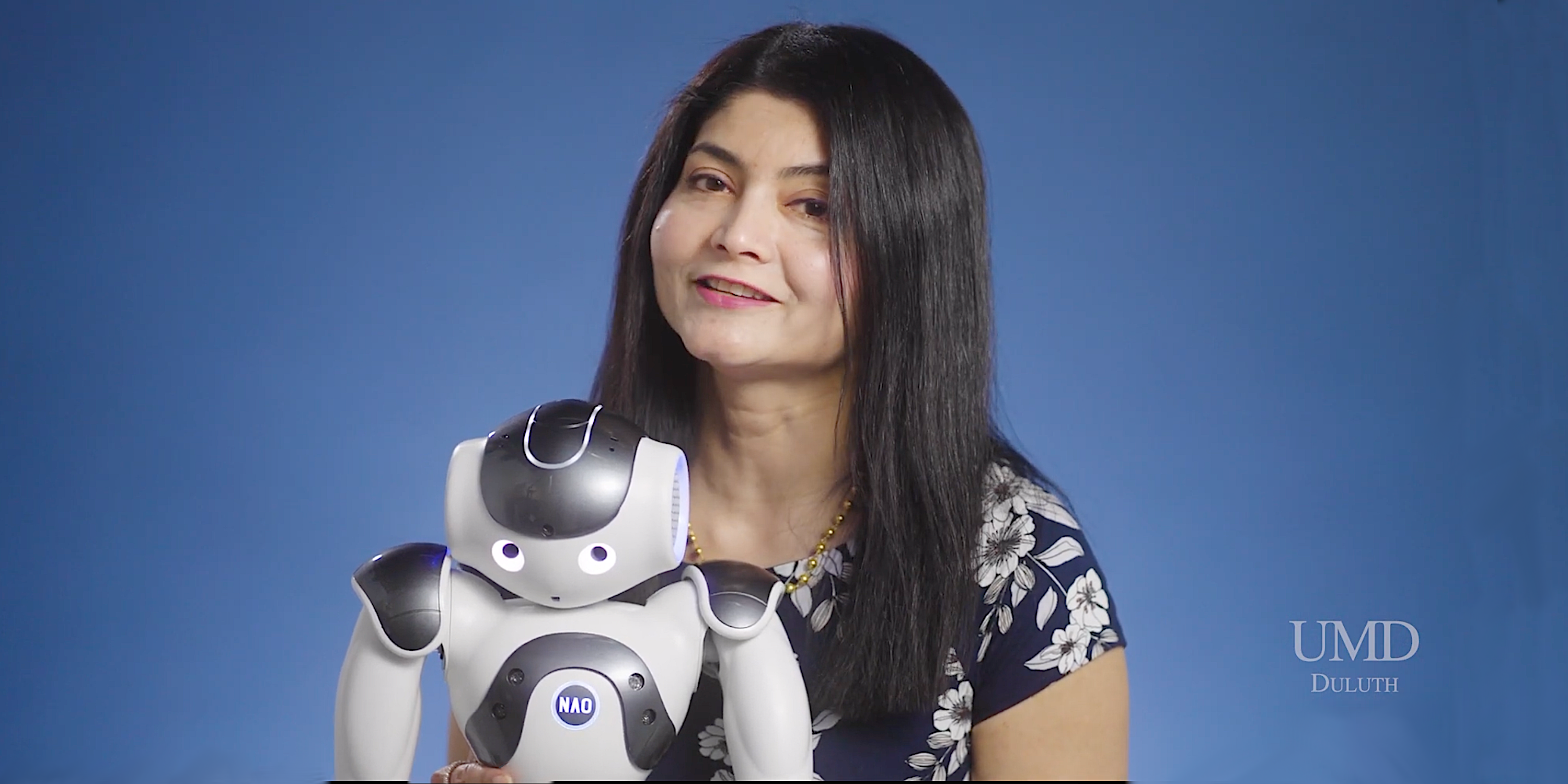 Arshia Khan with a robot