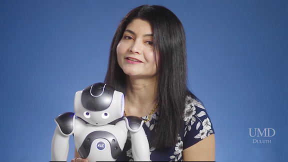 Arshia Khan with a robot