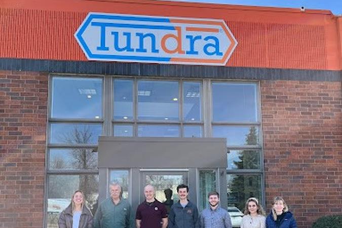 A photo of Applied Materials Science graduate students outside of Tundra Innovations.