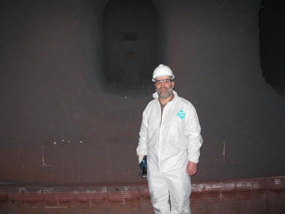 Professor Davis inspecting a burner port in a pelletizing furnace