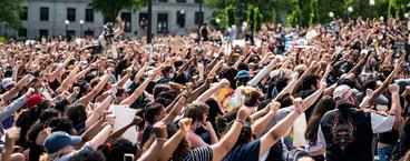 Demonstrators with their fists raised in unison