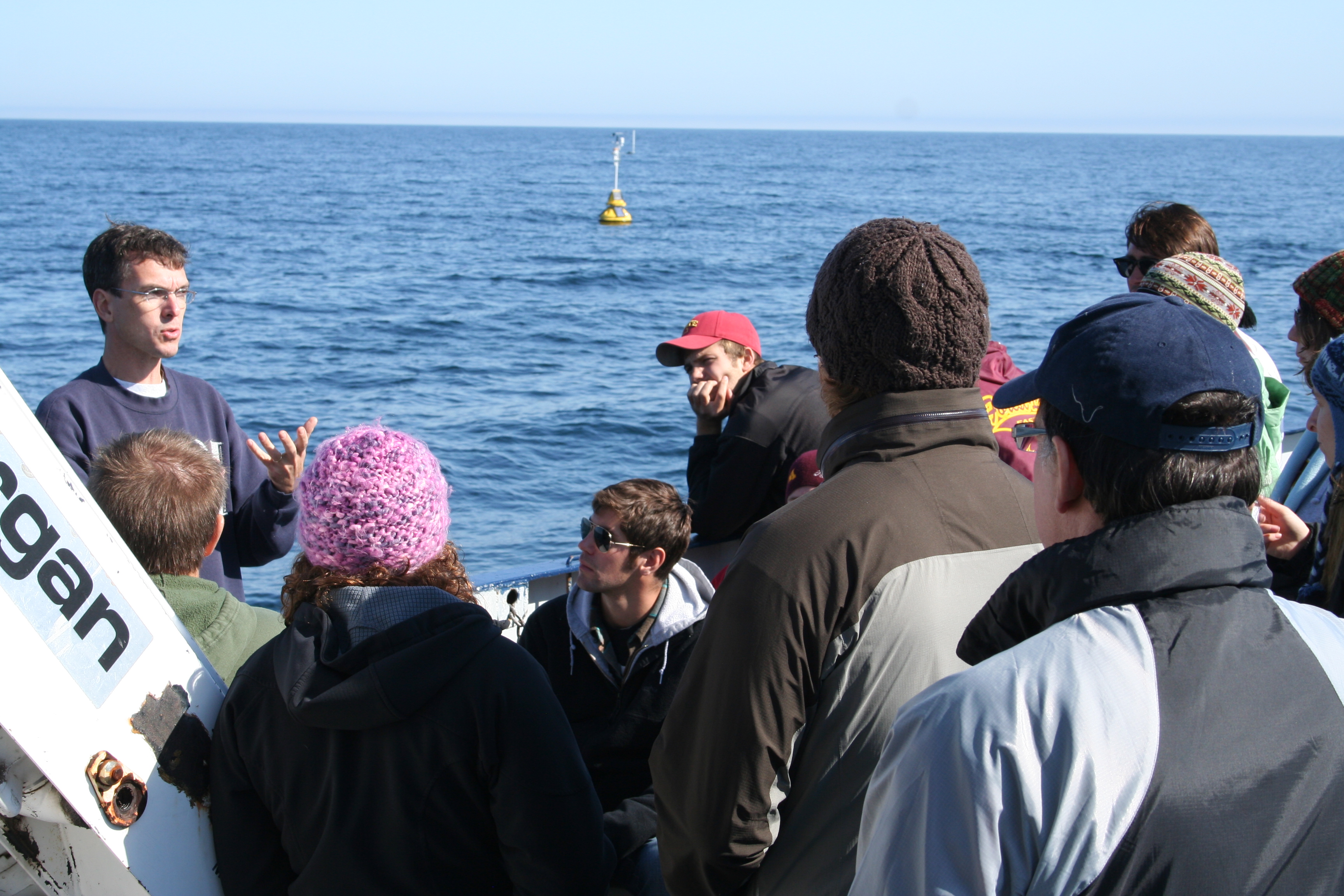 Graduate students hearing from an LLO professor on board the Blue Heron